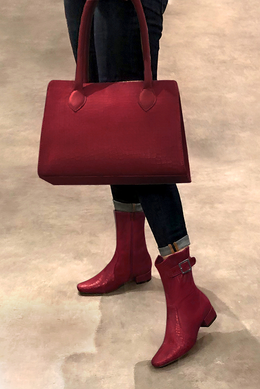 Burgundy red women's ankle boots with buckles on the sides. Round toe. Low block heels. Worn view - Florence KOOIJMAN
